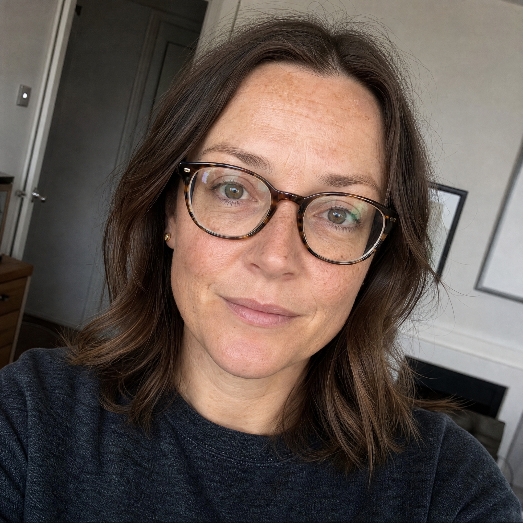 Portrait of a woman in her mid thirties wearing glasses