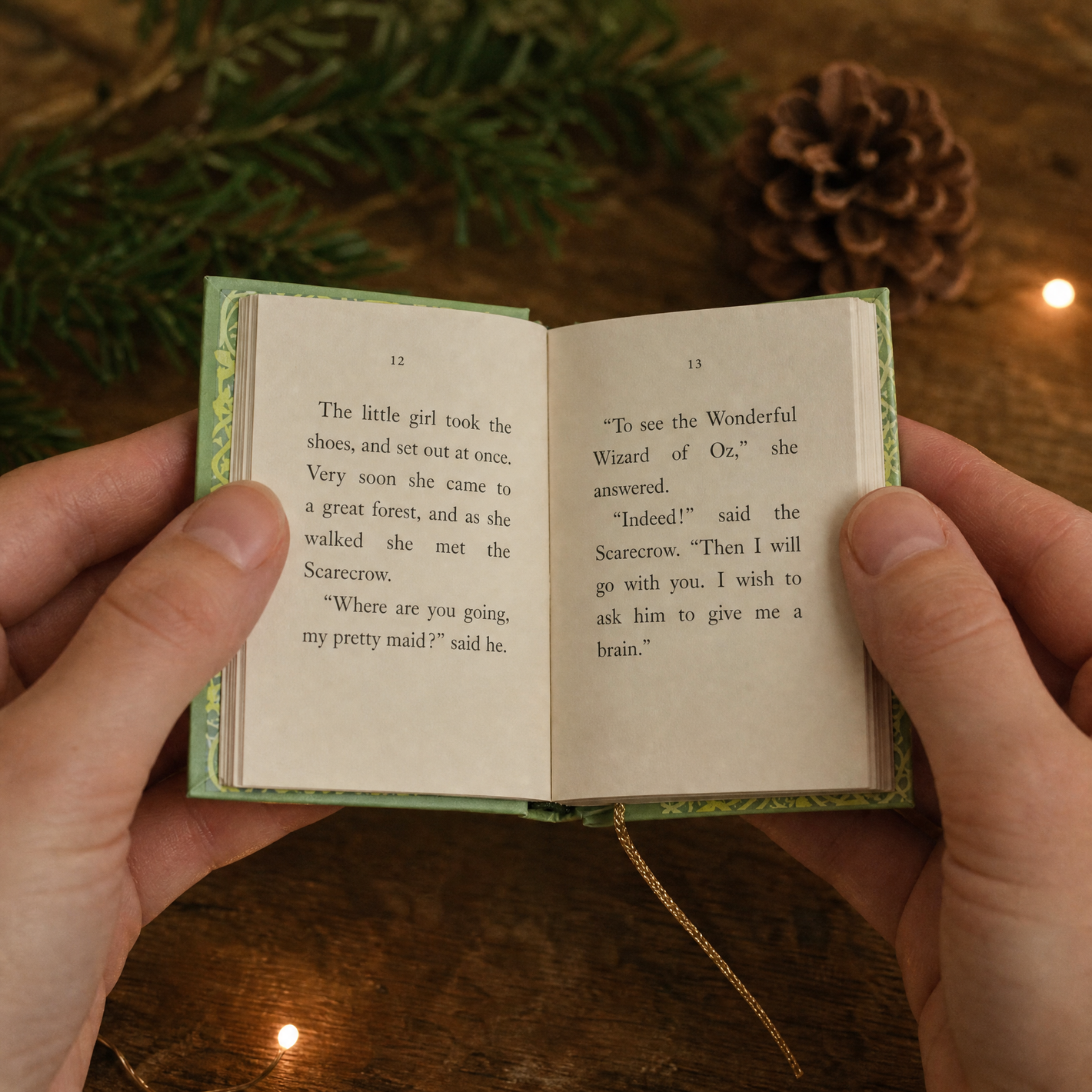 Two hands holding one of the mini books open, showing real printed pages